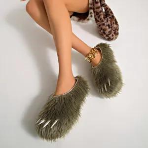 Detailed macro view of olive green faux fur claw slippers featuring silver spikes and platform