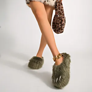Detail view of green faux fur claw slippers with metallic silver studs