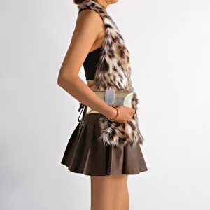 Side view detail of leopard print faux fur vest and brown pleated leather skirt