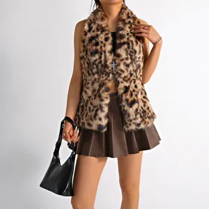 Detailed shot of a leopard print faux fur vest with a decorative silver cross