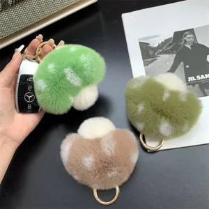 Hand-held plush mushroom keychains in soft macaron colors, rex rabbit fur detail.
