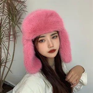 Macro detail of a plush pink faux fur trapper hat worn by a model for winter warmth