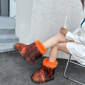 Macro view of fluffy faux raccoon fur snow boots with vibrant orange gradient tones