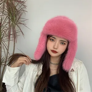 Detailed view of the soft pink faux fox fur texture on this winter earflap hat