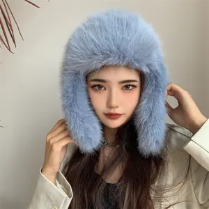 Close-up of a blue faux fur trapper hat with ear flaps for winter warmth.