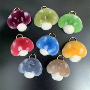 Group of colorful Rex rabbit fur mushroom keychains with gold-tone rings.
