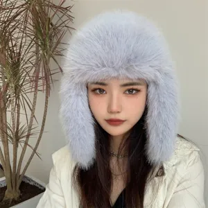 Lavender faux fur trapper hat with ear flaps shown on model for warm winter style