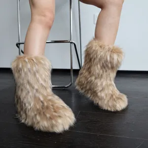 Detail view of fluffy faux raccoon fur snow boots on feet showing Y2K fashion style