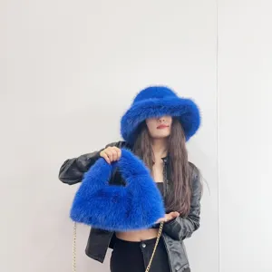Close-up of electric blue faux fox fur bucket hat and triangular hobo bag set for women