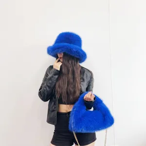 Stylish electric blue faux fox fur bucket hat and matching hobo bag set for winter fashion