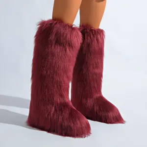 Gros plan de bottes de neige luxueuses en fausse fourrure bordeaux pour l'hiver élégant