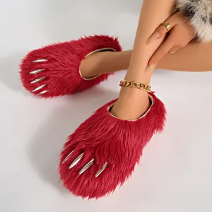 Detailed view of red faux fur monster claw slippers featuring metallic silver claw accents