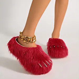 Detail view of pink fuzzy claw slippers with silver metallic nails and platform sole