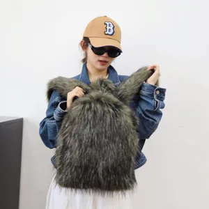 Trendy large Y2K faux raccoon fur backpack with long fluffy hair styled on a model