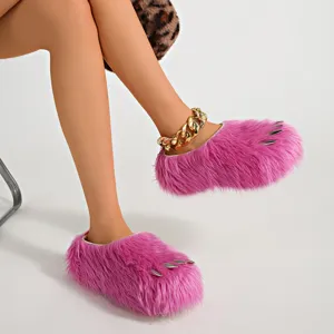 Detail view of bright pink faux fur monster claw slippers featuring silver claw accents