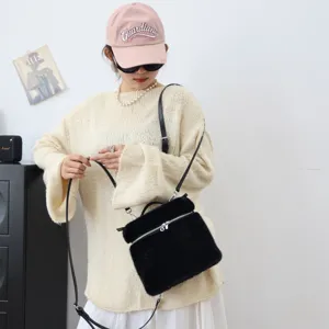 Nahaufnahme einer weichen schwarzen Kunstpelz-Handtasche mit silbernem Reißverschluss