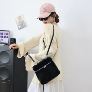 Nahaufnahme einer stylischen schwarzen Plüsch-Umhängetasche an einem asiatischen Model