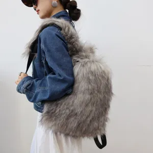 Side view of a large grey faux raccoon fur backpack worn with a denim jacket