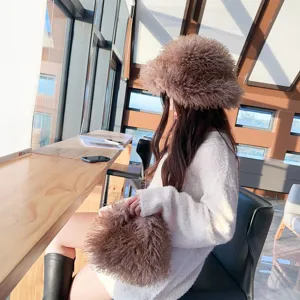 Stylish brown curly faux lamb wool bucket hat and matching fuzzy bag in a cozy cafe setting.