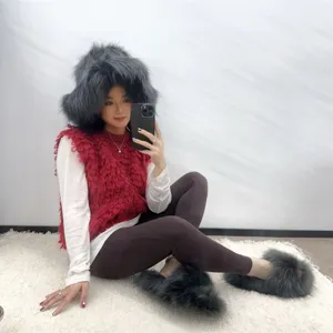 Lifestyle shot of punk style faux raccoon fur hat and matching slippers in dark grey