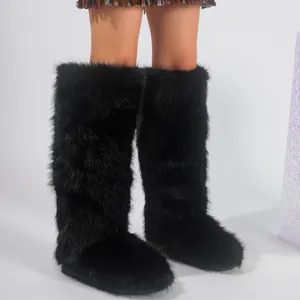 Detailed view of knee-high black faux fur snow boots in Y2K style for women
