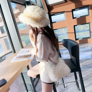 Cozy white faux sheep fur bucket hat with matching plush crossbody bag for winter wear