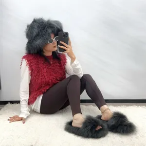 Model wearing punk style faux raccoon fur slippers and matching fluffy hat set