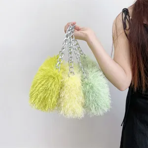 Detailed view of three colorful fuzzy faux fur handbags with silver chain handles