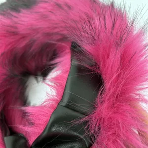 Detailed close-up showing hot pink faux raccoon fur and black faux leather material