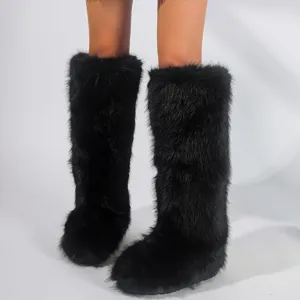 Close-up of black faux fur high-top snow boots for women in Y2K warm winter style