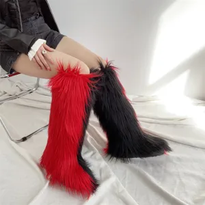 Macro view of fluffy faux fur knee-high snow boots in red and black split colors