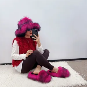 Detail view of hot pink faux fur bucket hat and matching slippers set worn by a model.