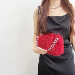 Chic red fluffy faux fur baguette handbag featuring a chunky silver chain strap and sleek design