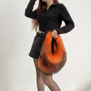 Detailed texture of orange and brown faux raccoon fur tank-style handbag for women