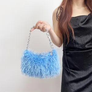 Close-up detail of a bright blue faux fur evening bag with metallic silver chain strap