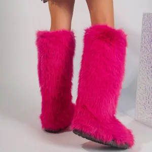 Detail of bright pink faux fur knee-high boots featuring fluffy texture and Y2K style