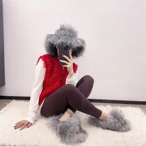 Luxury grey faux fur hat and matching slippers set worn by a model in a cozy setting