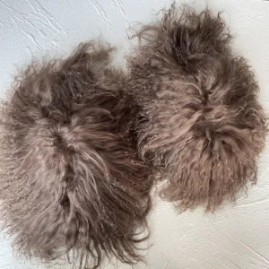 Detailed close-up view of premium fluffy Mongolian curly fur slides in dusty mauve