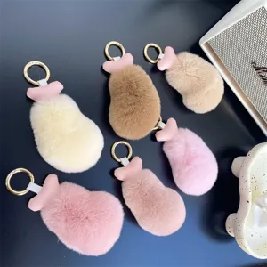 Collection of fluffy faux rabbit fur chicken drumstick keychains in various soft pastel colors.