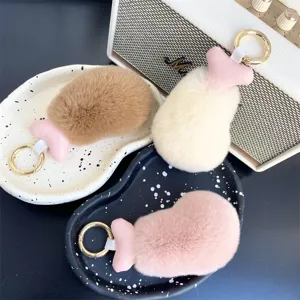 Close-up of soft faux rabbit fur chicken drumstick keychains in three pastel colors