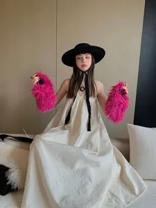 Vibrant fuchsia Mongolian fur slides displayed on a fashion model for a stylish lifestyle look