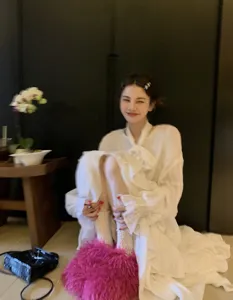 Cozy pink Mongolian fur slides styled with white lace dress for winter indoor comfort