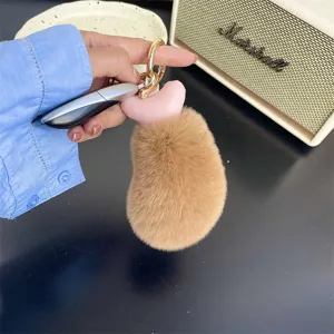 Detailed view of the soft rex rabbit fur chicken drumstick keychain in brown color.