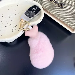 Close-up of fluffy pink rex rabbit fur chicken drumstick keychain charm