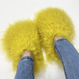 Close-up of yellow curly Mongolian fur slippers showing soft and fluffy texture details.