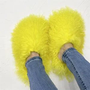 Close-up detail of bright yellow Mongolian fur slides showing fluffy lamb wool texture
