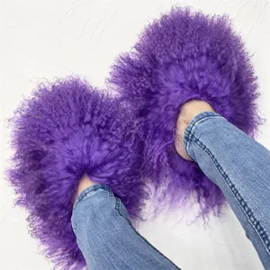 Detailed macro view of vibrant purple fluffy Mongolian lamb fur slippers worn with blue jeans