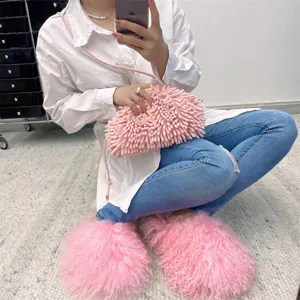 Detailed shot of pink Mongolian fur slides and matching textured bag on model