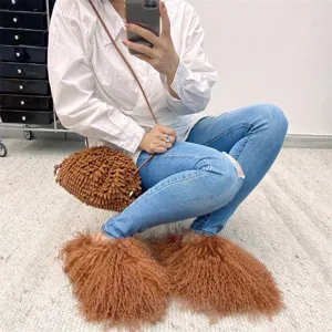 Close-up of luxurious brown Mongolian sheep fur slides with long curly texture