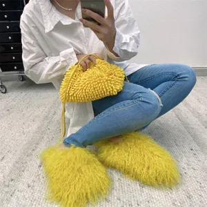 High-angle close-up of vibrant yellow Mongolian fur slides paired with casual blue jeans